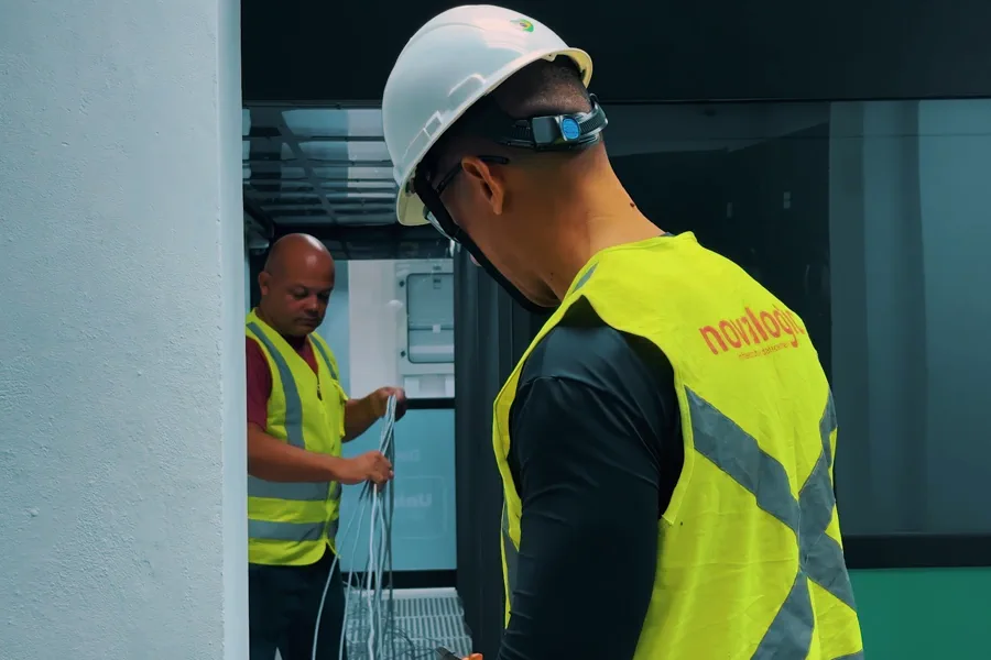 Técnicos da Novalogic lançando cabeamento em obra